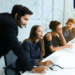 Modern employees collaborating through the use of people management technology to streamline HR tasks and improve teamwork.